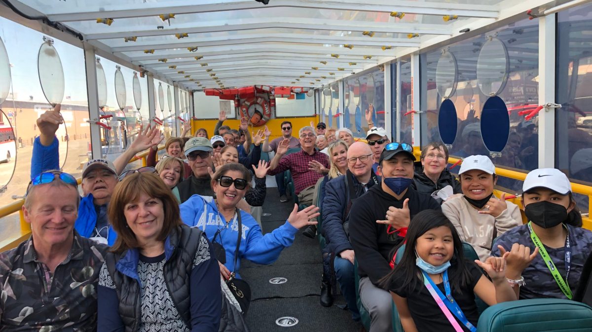 IMG_5082 a group of people standing in front of a crowd posing for the camera